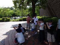 完成した望遠鏡で遠くの景色を見る参加者